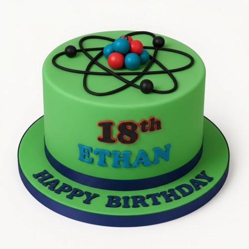 Green birthday cake with black atom design, red and blue spheres, and custom age message.