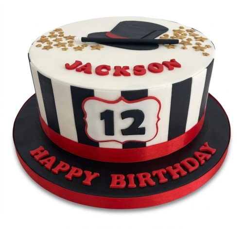 Round white cake with black and white stripes, a black top hat, magic wand, and gold stars.