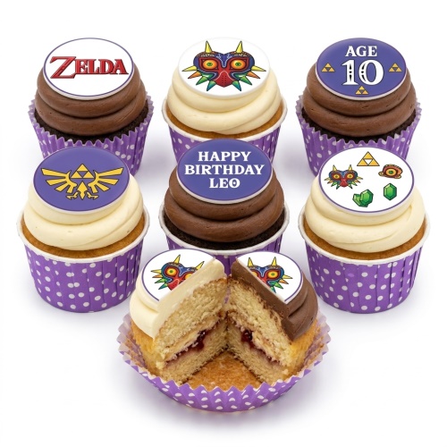 Zelda themed cupcakes with Majora's Mask, Triforce, 'Zelda' logo, 'Age 10', and 'Happy Birthday Leo' toppers.