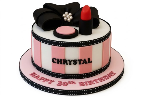 Round pink and white striped cake with black bow, red lipstick, and compact decorations.