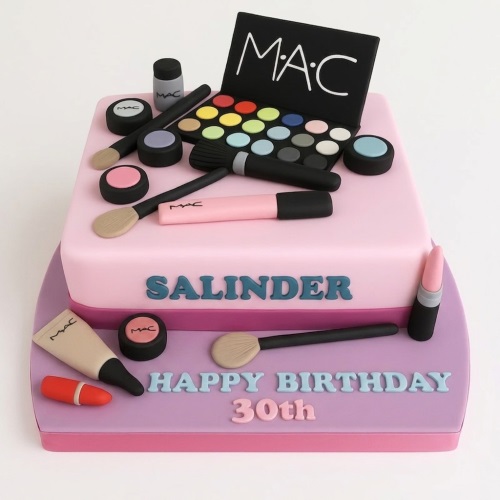 Two-tier pink and purple cake decorated with edible MAC makeup, brushes, and lipstick.