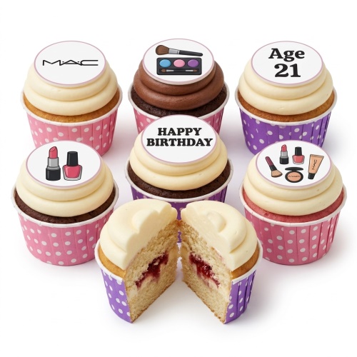 A selection of cupcakes with white and chocolate frosting, decorated with edible makeup-themed toppers including lipstick, eyeshadow, brushes, and a designer logo, with custom age and happy birthday messages.