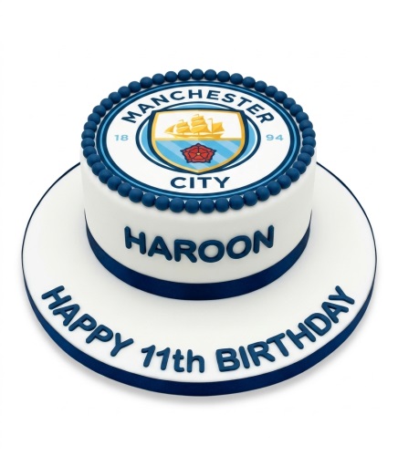 Round white football cake with Manchester City FC logo and blue edible pearls, with space for custom name and message.
