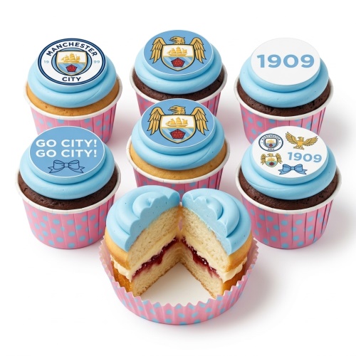 Manchester City football themed cupcakes with blue frosting and club crest toppers, in pink polka dot cases.