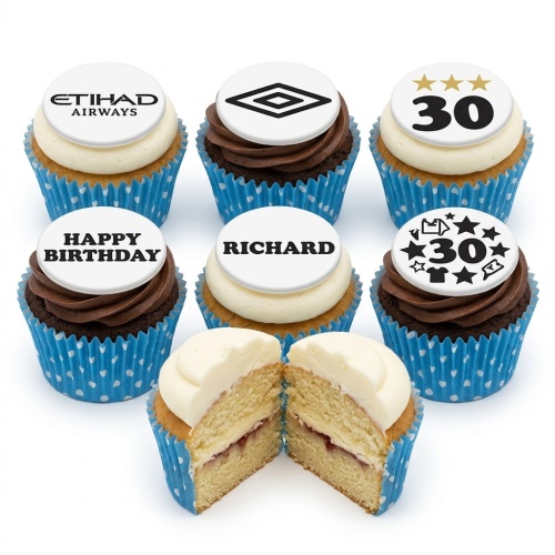 A selection of football theme birthday cupcakes with custom age and brand logo toppers, in blue polka dot wrappers.