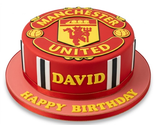 Round red Manchester United birthday cake with club crest, footballs, and a personalised message on the board.