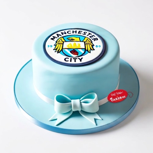 Single-tier light blue Manchester City Football Club birthday cake with club crest and bow.