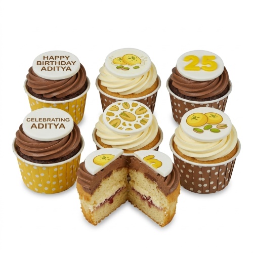 A selection of pistachio-themed birthday cupcakes with chocolate and vanilla frosting, some with custom age and message toppers.