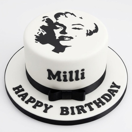 White round birthday cake with black Marilyn Monroe silhouette and personalised message.