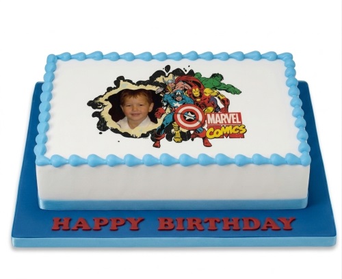 Rectangular white cake with blue border, featuring an edible image of Marvel Superheroes and a custom child's photo.