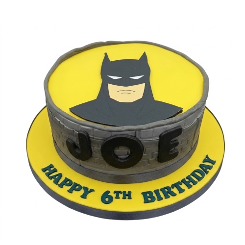 Round yellow and grey Batman themed birthday cake with a custom name and age message.