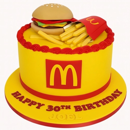 Round yellow cake with red trim, topped with a 3D burger and a carton of fries, featuring the McDonald's 'M' logo on the side.