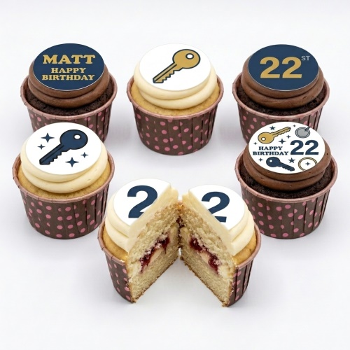 A selection of Key to the Door birthday cupcakes with custom age and key design toppers, in brown polka dot cases.