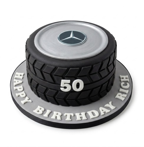 Round black car wheel birthday cake with silver hubcap and Mercedes-Benz logo, custom age and message.