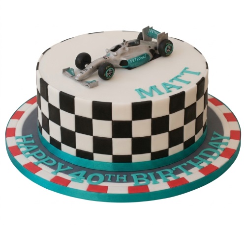Round white and black checkerboard cake with a silver F1 racing car and racing track border.