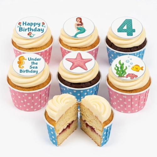 Under the sea themed cupcakes with mermaid, seahorse, starfish, fish, and crab toppers, featuring a custom age.