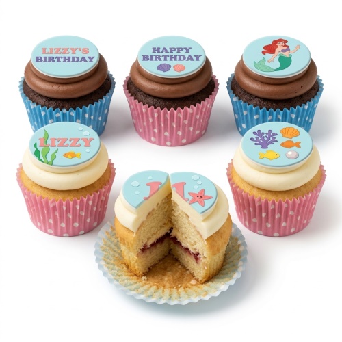 Mermaid themed birthday cupcakes with sea creatures, seashells, and custom age topper.