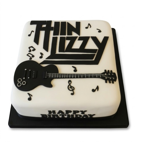 White rectangular cake with black Thin Lizzy logo, electric guitar, and musical notes.