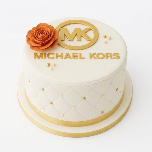 Elegant white Michael Kors themed birthday cake with gold logo, brand name, and an orange sugar rose.