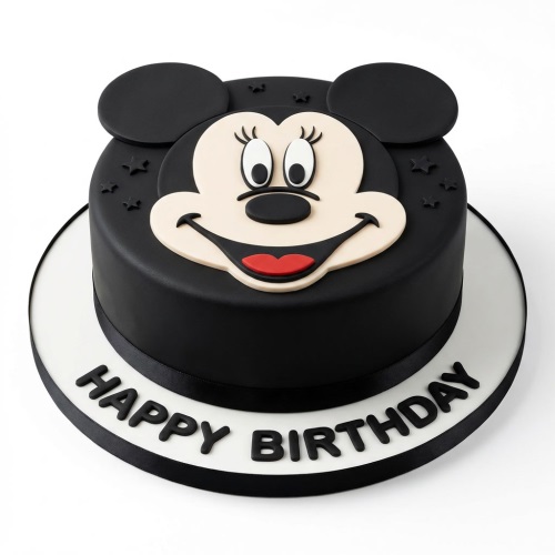 Round black Minnie Mouse birthday cake with a cream face and black ears, with 'Happy Birthday' written on the board.