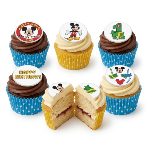 A set of Mickey Mouse themed birthday cupcakes with chocolate and vanilla frosting, blue and yellow wrappers, and various Mickey Mouse toppers including a number 1.