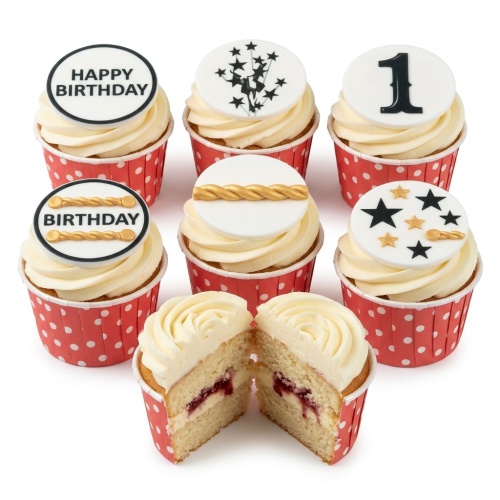 White frosted cupcakes in red polka dot cases with black and gold celebration toppers, including 'Happy Birthday' and stars.