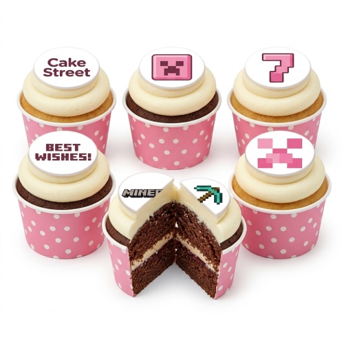 Set of six cupcakes with white frosting and pink polka dot cases. Toppers feature Minecraft pixelated designs like a Creeper face, pickaxe, and 'MINECRAFT' logo, along with 'BEST WISHES!'.