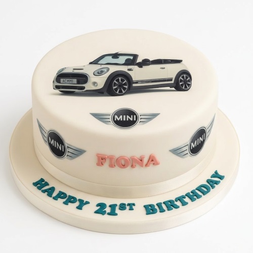 Two-tier round cream birthday cake with an edible image of a white Mini Cooper car and Mini logos on the side.