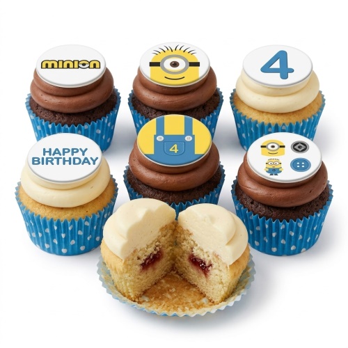 Set of Minions themed cupcakes with chocolate and vanilla frosting, blue polka dot cases, and custom age and message toppers.