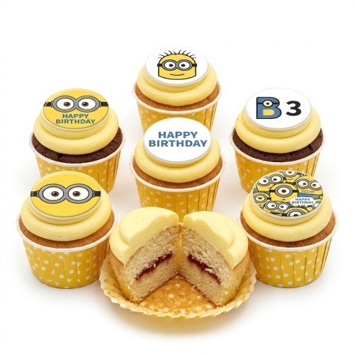 Assortment of Minions theme birthday cupcakes with yellow frosting and custom toppers.