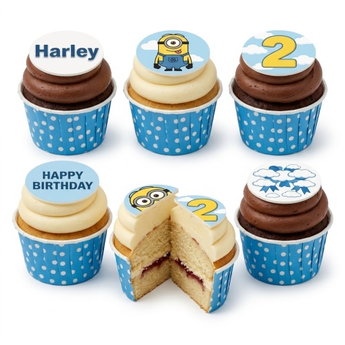 Minion themed cupcakes with blue polka dot wrappers, vanilla and chocolate frosting, and customisable edible toppers including a Minion character, a number 2, a name, and a "Happy Birthday" message.