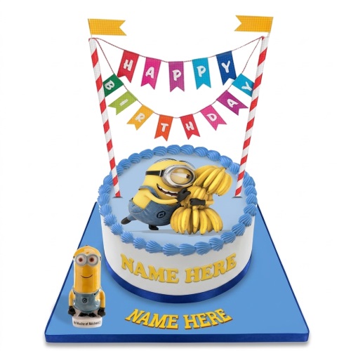 Round white and blue Minions birthday cake with a Minion holding bananas, a 'Happy Birthday' banner, and a small Minion figurine.