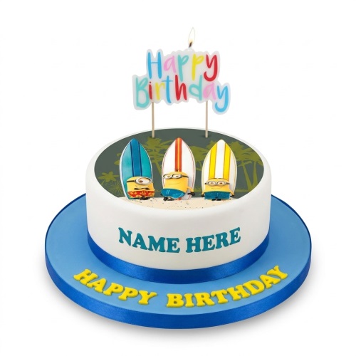 Round white birthday cake with Minions and surfboards on a beach scene, with a 'Happy Birthday' candle and space for a custom name.
