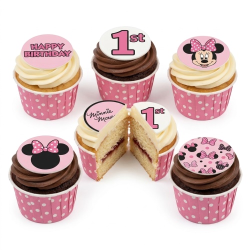 Minnie Mouse 1st birthday cupcakes with "1st" and "Happy Birthday" toppers, pink polka dot wrappers.