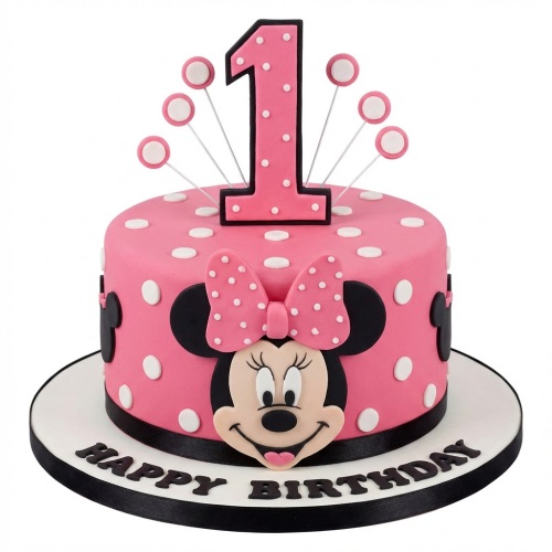 Pink Minnie Mouse 1st birthday cake with polka dots, number one topper, and 'Happy Birthday' message.