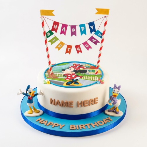 Round white birthday cake with Minnie Mouse, Donald Duck, Daisy Duck, and a "Happy Birthday" banner.