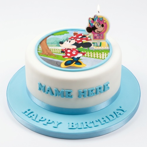 Round white Minnie Mouse birthday cake with edible image, blue ribbon, and blue cake board.