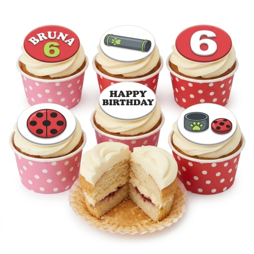 Cupcakes with white frosting and edible toppers featuring ladybug, paw print, and custom age designs.