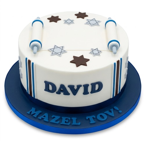 Round white cake with blue and brown Torah scrolls, Star of David decorations, and 'MAZEL TOV!' message.