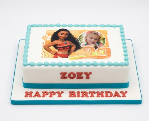 Square white Moana birthday cake with child's photo and blue piping.