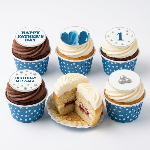 A selection of cupcakes with blue and white polka dot wrappers, topped with chocolate and vanilla frosting and various edible toppers including 'Happy Father's Day', '1', 'Birthday Message', and blue abstract design.