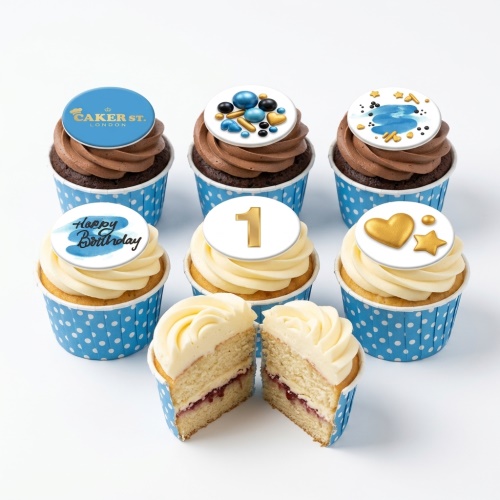 Blue and gold cupcakes with various decorative toppers, including a 'Happy Birthday' message and a custom age topper.
