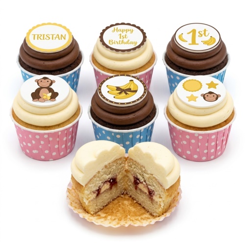 Monkey and banana themed cupcakes with '1st Birthday' and custom name toppers.