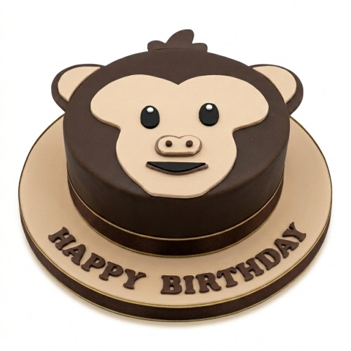 Round brown monkey face birthday cake with a beige face and 'Happy Birthday' message on the cake board.