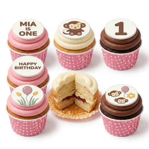 Monkey themed birthday cupcakes with pink and chocolate frosting, featuring custom age and message toppers.