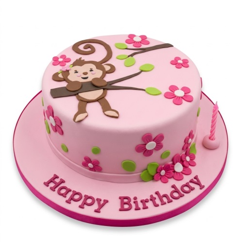 Pink round birthday cake with a fondant monkey on a branch, pink flowers, green leaves, and 'Happy Birthday' message.