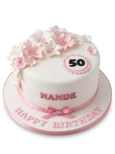 White round birthday cake with pink and white sugar flowers, pink ribbon, custom age topper, and personalised name.