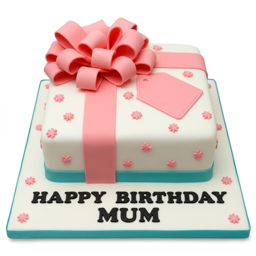 White square cake decorated as a gift box with a large pink bow, pink ribbon, pink flowers, and a teal base.