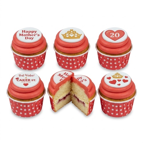 Mother's Day cupcakes with pink frosting, white toppers, gold crowns, and red hearts in polka dot wrappers.