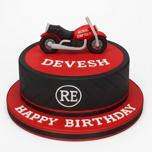 Round red and black birthday cake with a red Royal Enfield motorcycle topper and tyre tread pattern.